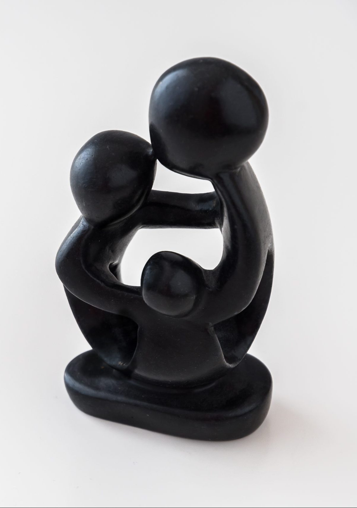 African,Black,Wooden,Figure,Of,A,Family,Hugging,Each,Other.